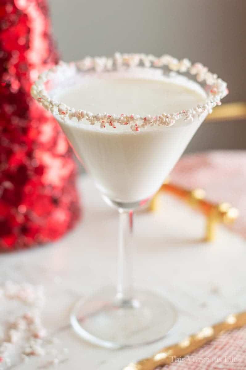 Candy Cane Martini in a glass with candy cane rim