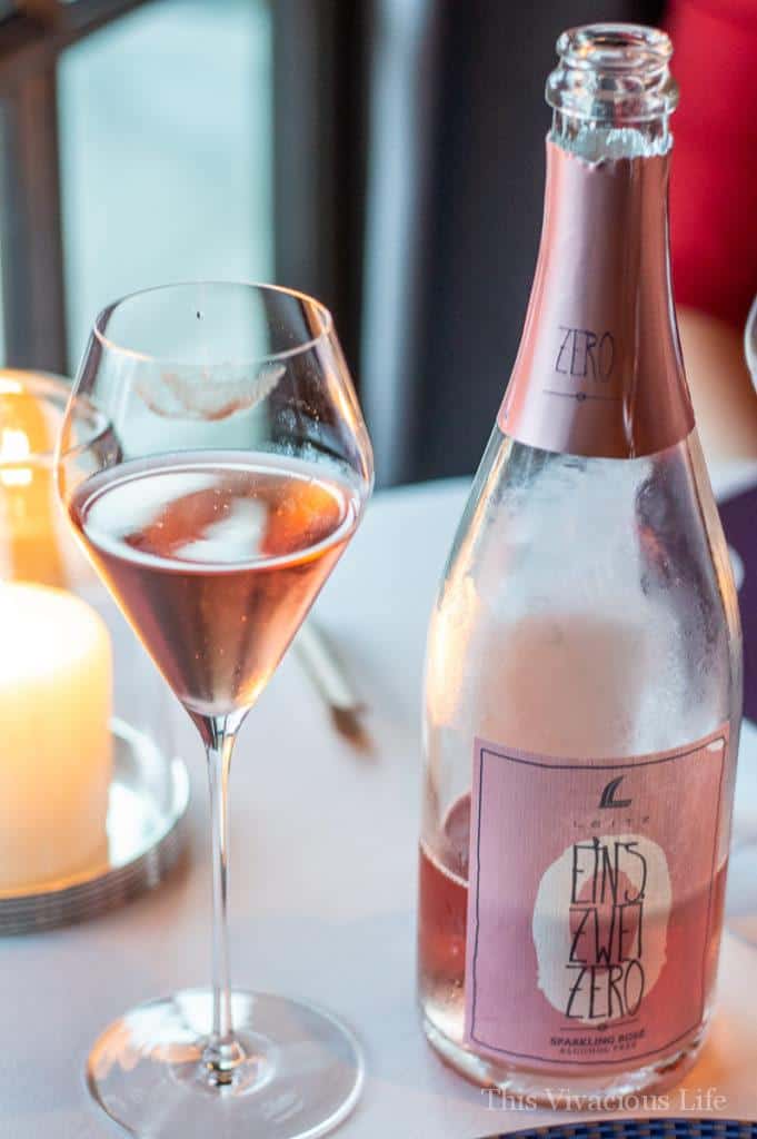 A bottle and a glass of non-alcoholic rose wine