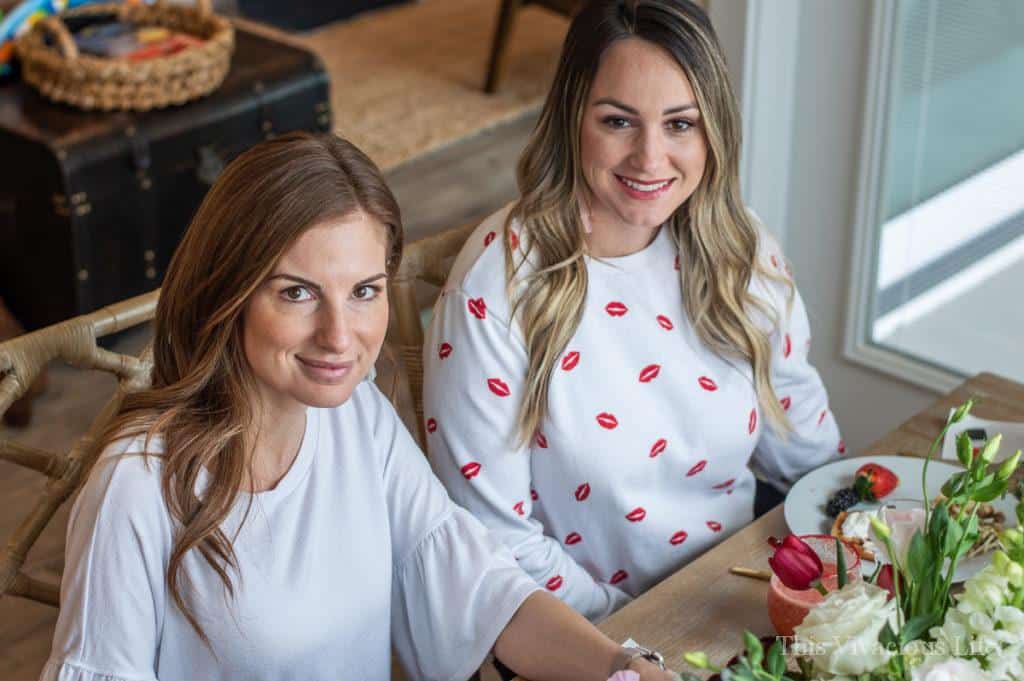 Two girls smiling in white shirts