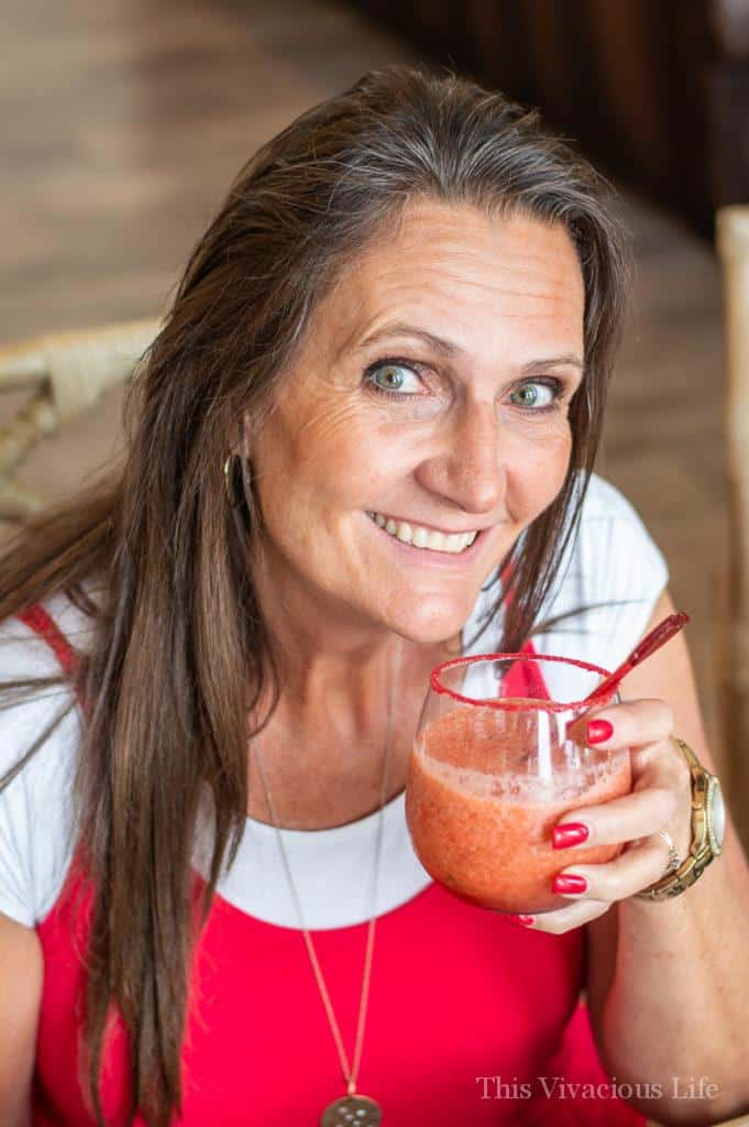 Brown haired woman holding a red drink