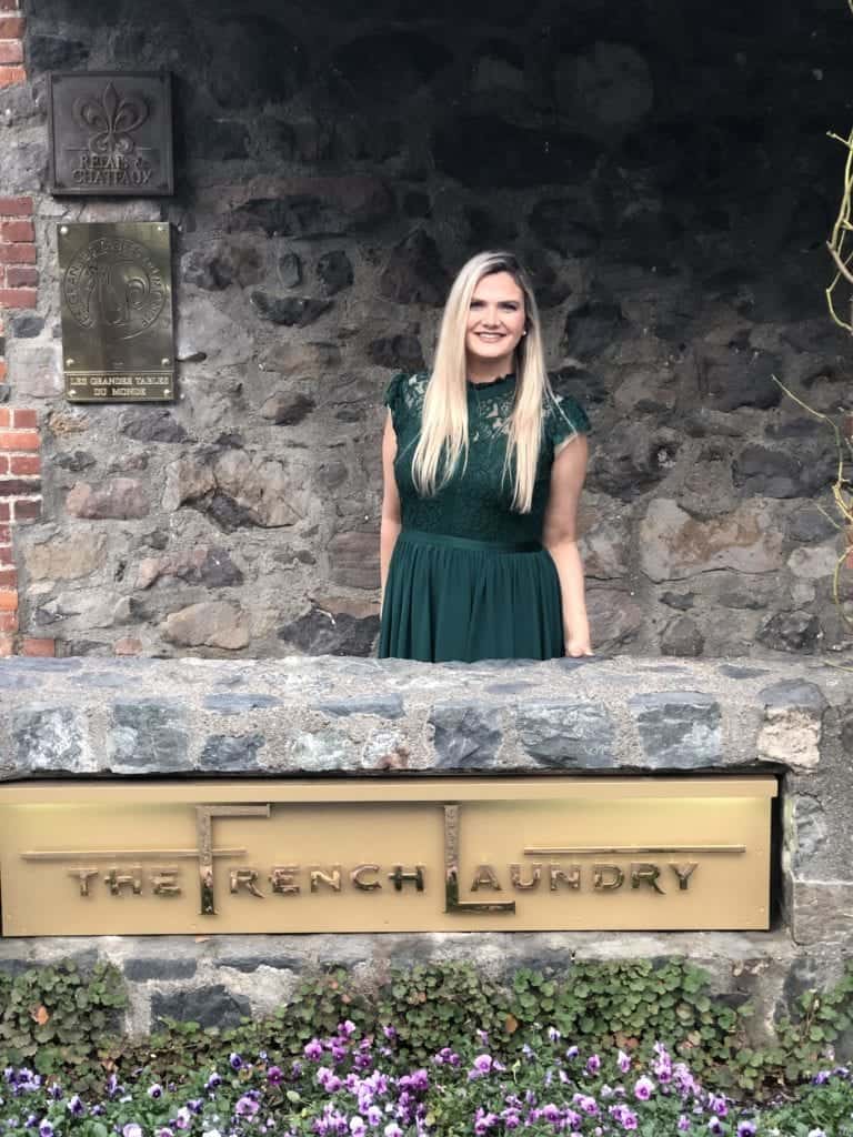 Woman in green dress in front of French Laundry