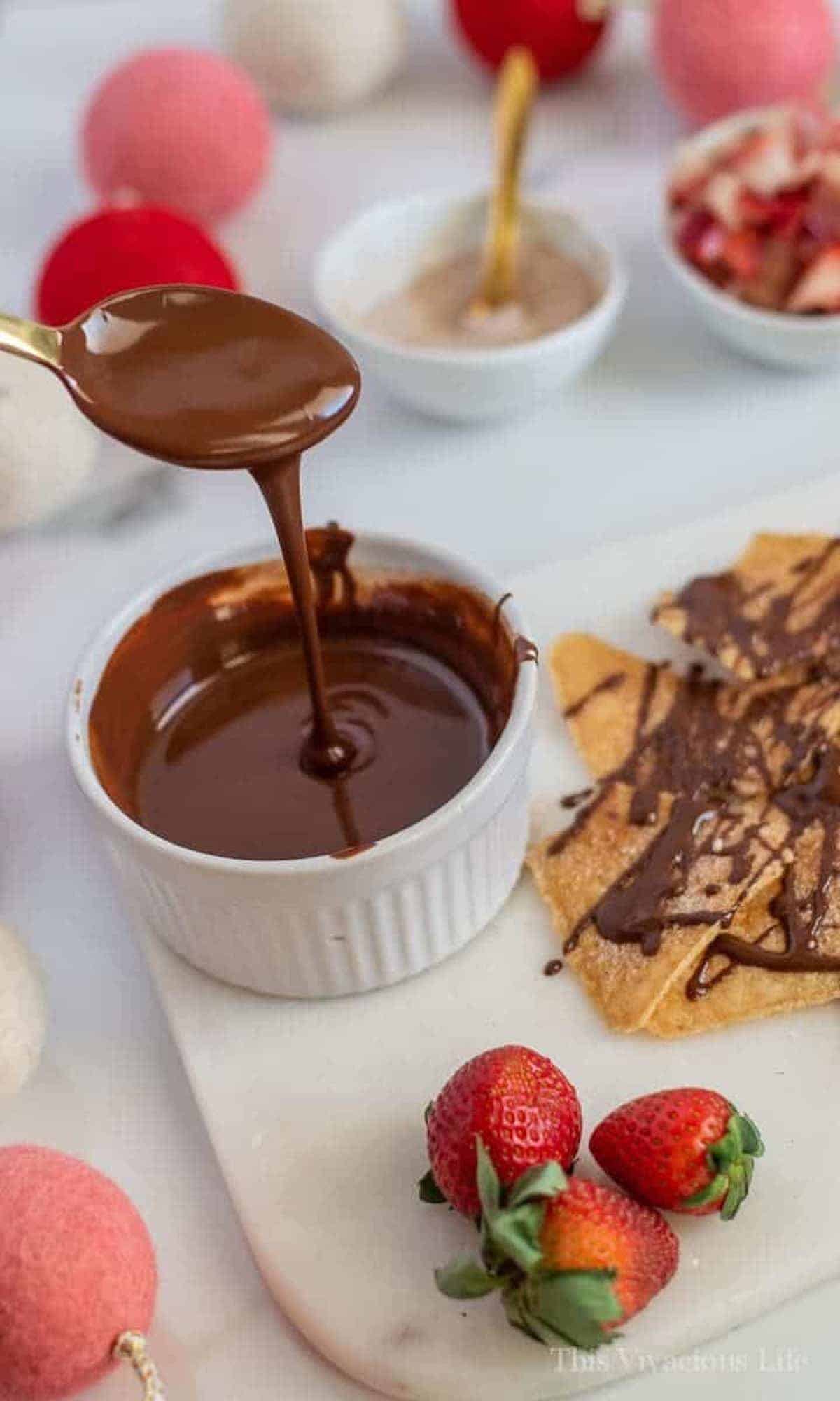 Vegan chocolate sauce on a spoon and in a bowl