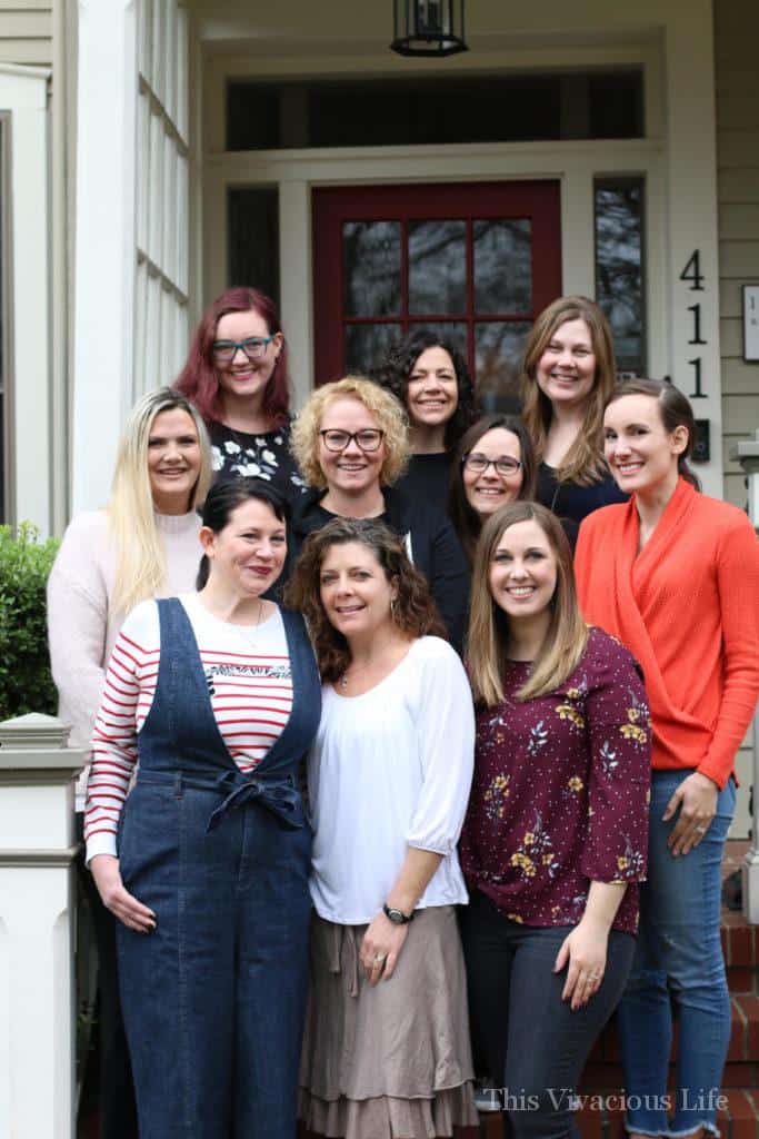 Girls on front porch steps smiling