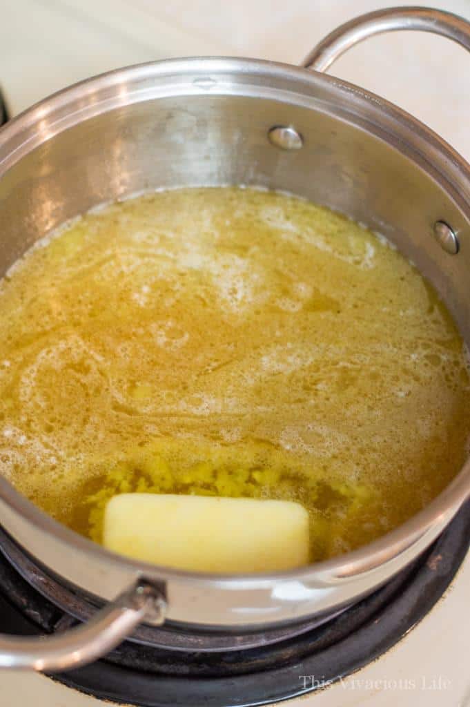 Chicken broth and butter in a silver pot