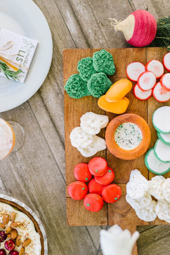 Vegetable decorated sugar cookies on a wood platter