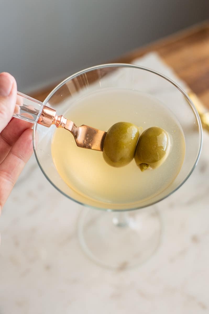 Non-alcoholic vodka dirty martini overhead shot with two green olives