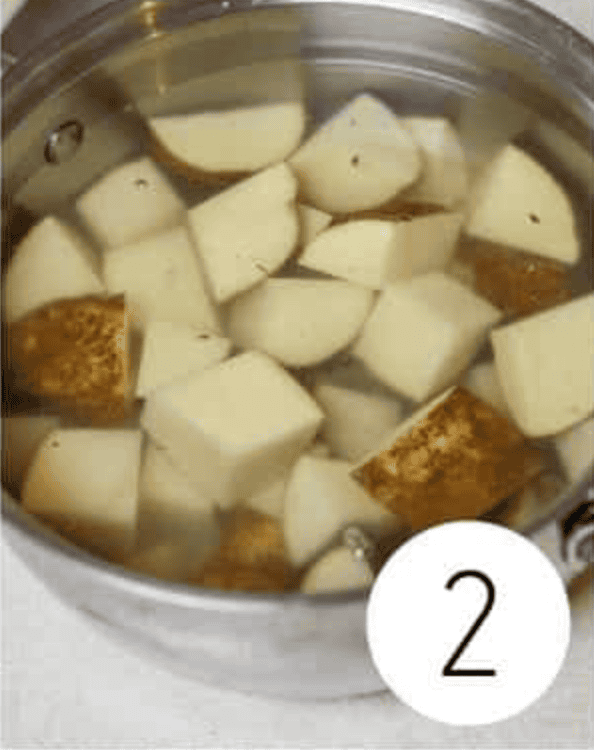 Non Alcoholic Dirty Martini Mocktail ingredients in a pot with potatoes in water