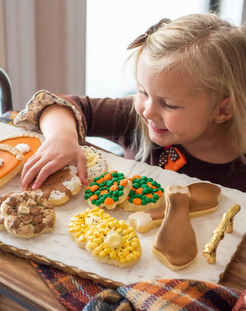 Little girl with thanksgiving sugar cookies