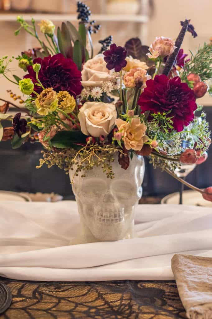 Halloween flowers in a white skull vase