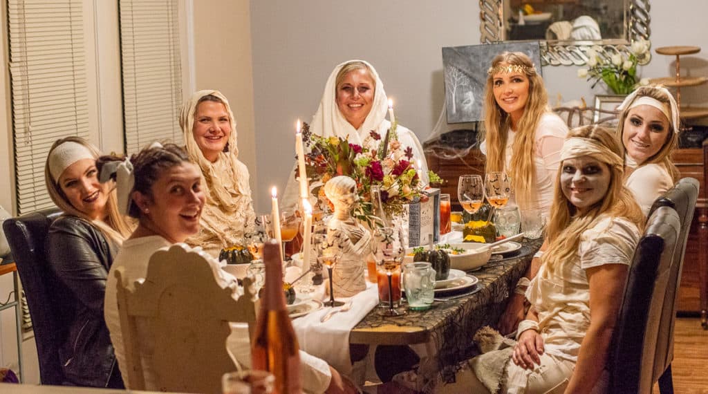 Mummy costume girls sitting at a table