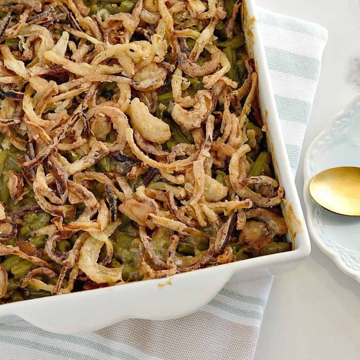 Gluten Free Green Bean Casserole with Homemade Fried Onions in a white dish