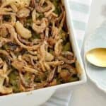Gluten Free Green Bean Casserole with Homemade Fried Onions in a white dish
