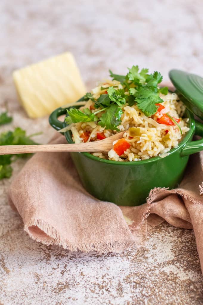 Green Chile rice in a. green bowl with cilantro