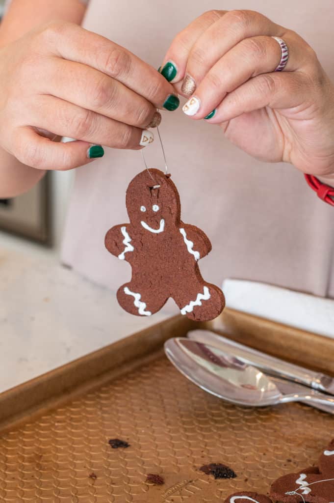 DIY gingerbread ornaments being held in hands