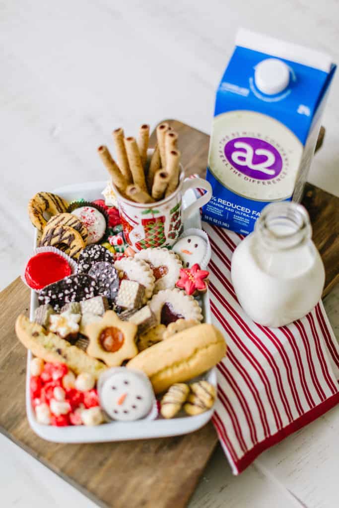 Milk and cookies on a Christmas platter with a towel