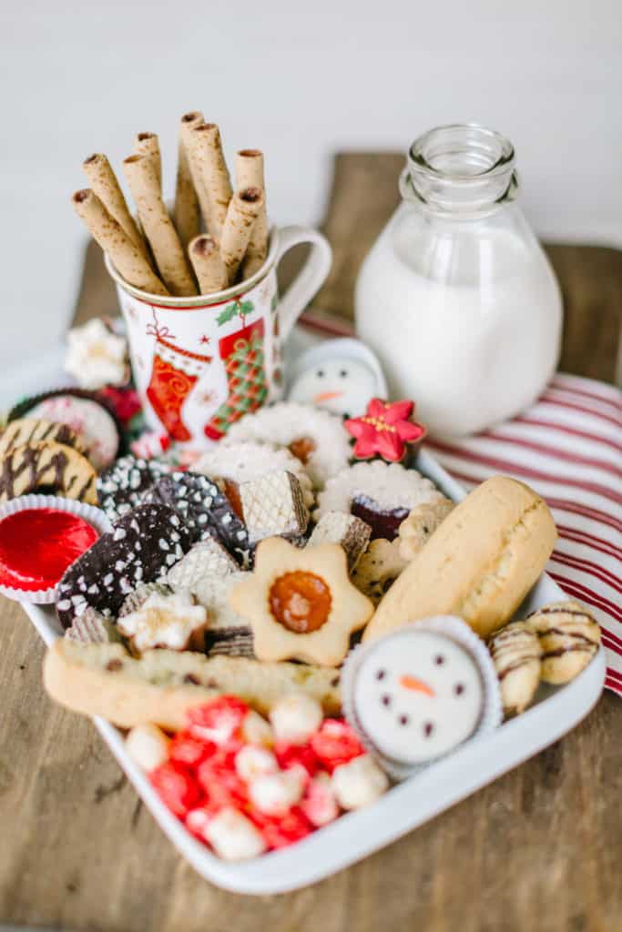 White tray with Christmas cookies and milk