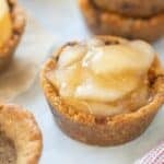 Easy Gluten Free Apple Pie Cookie Cups prepared with other cookie shells stacked in the back