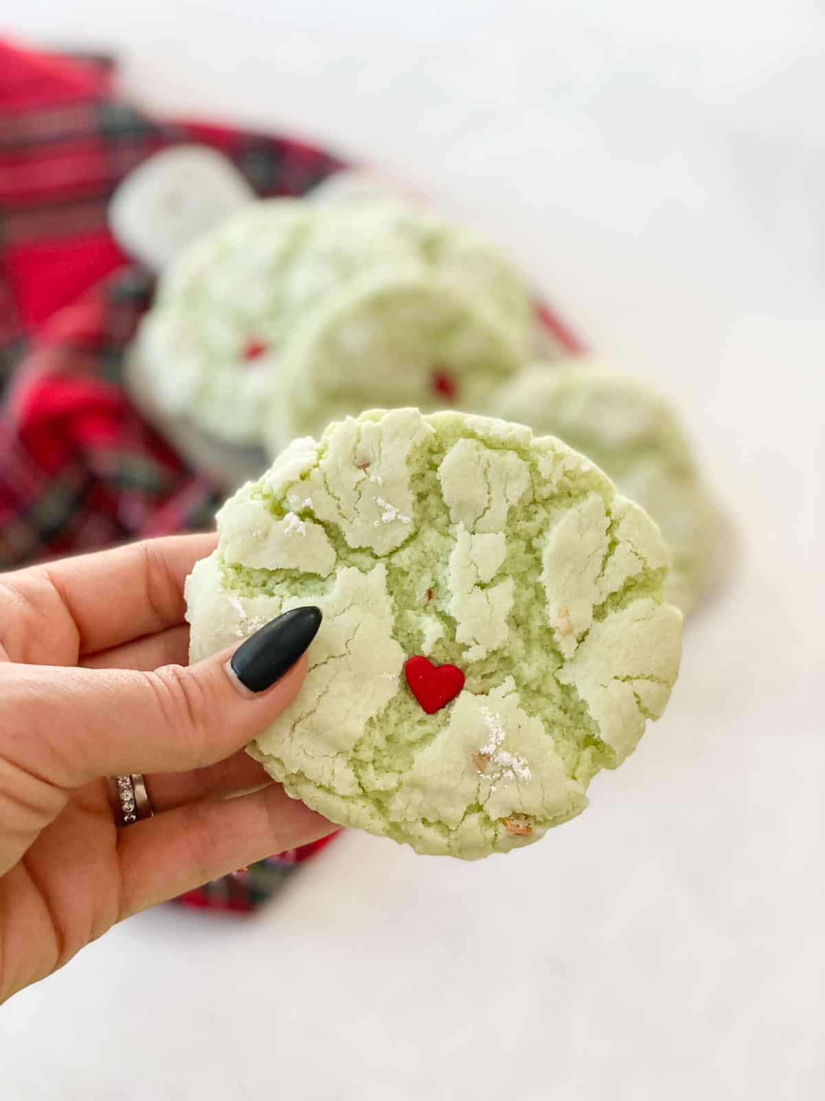 Grinch cookies in a hand