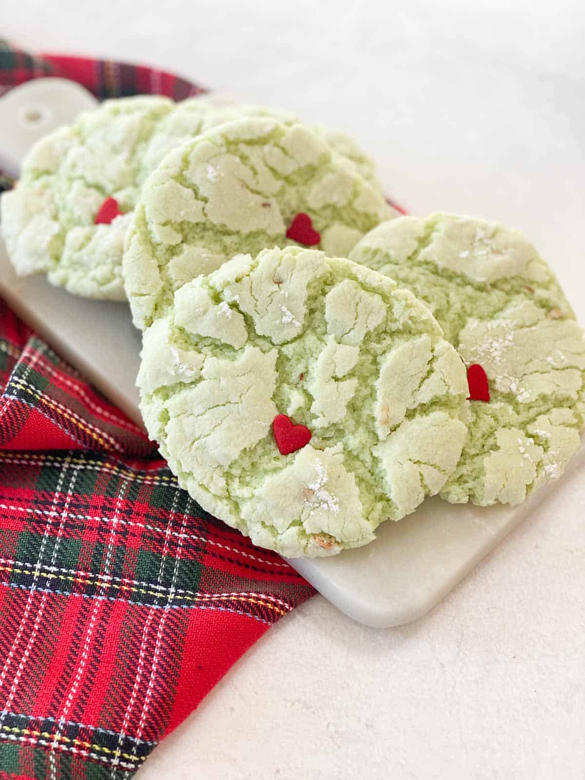 Grinch cookies on a marble plate