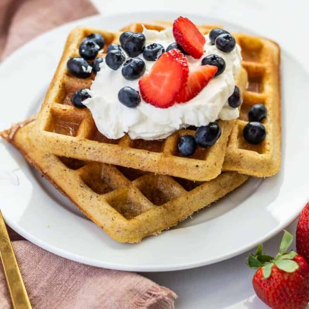 gluten-free waffles in a stack on the white plate