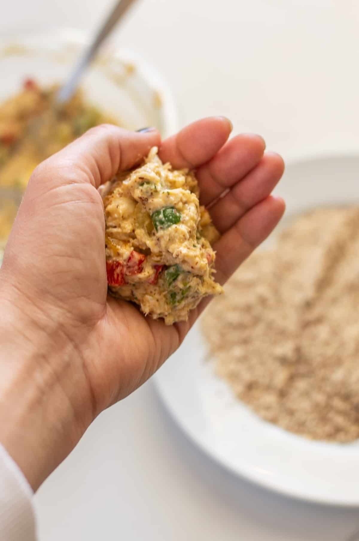 Whole30 crab cakes scoop in a hand