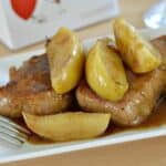 Instant Pot Pork chops on a white plate with apples