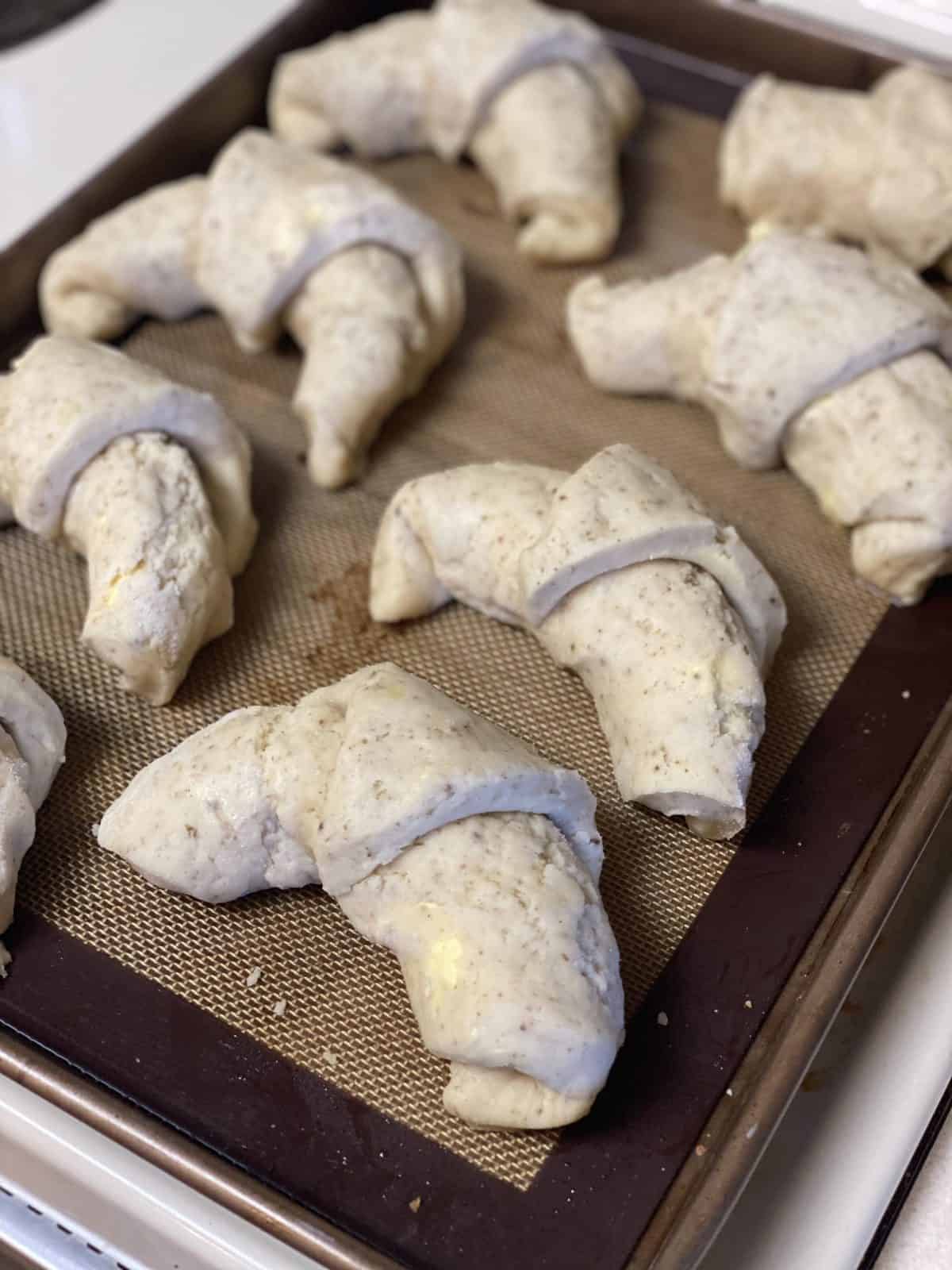gluten-free sourdough crescent rolls unbaked on a cookie sheet