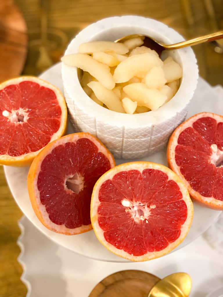 grapefruit and apples in marble containers