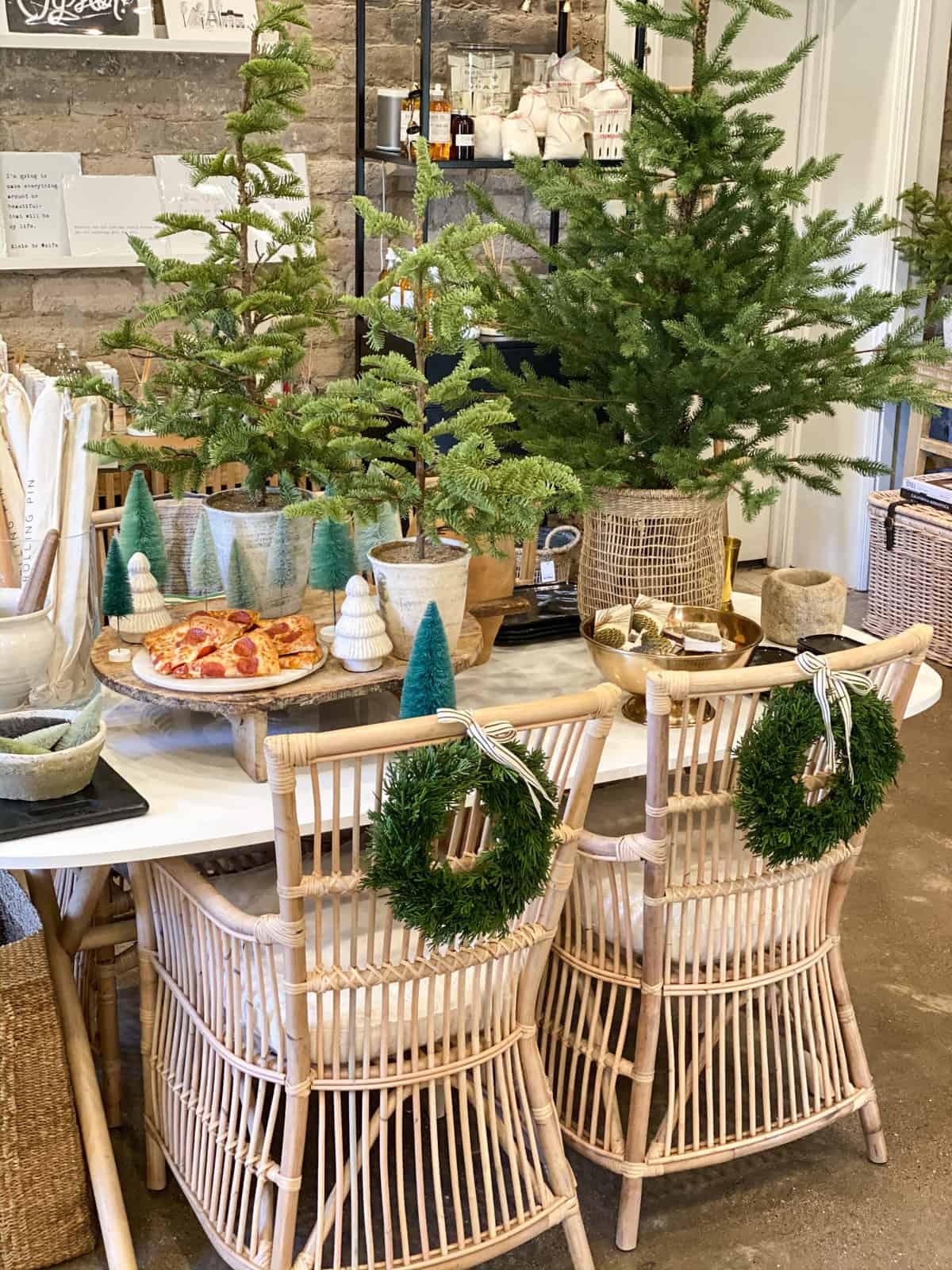 Modern table with green wreaths on chairs