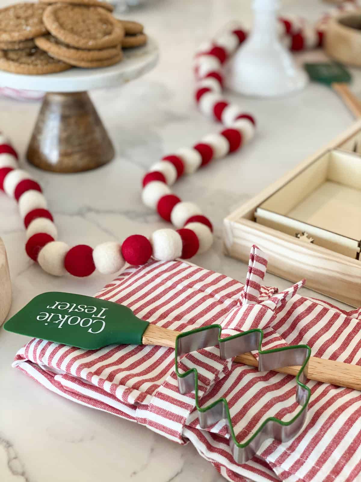 A spatula and holiday apron with cookie cutter