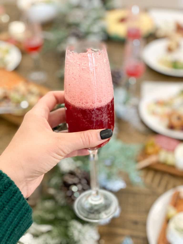 Cranberry mocktail in a glass in a hand