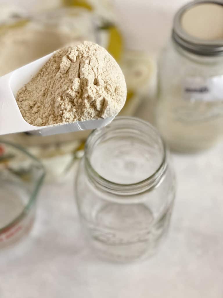 Sorghum flour being poured into a jar