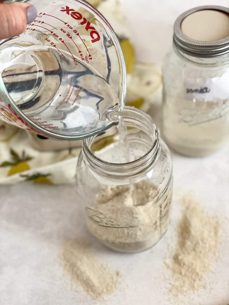 Water being poured into gluten-free sourdough