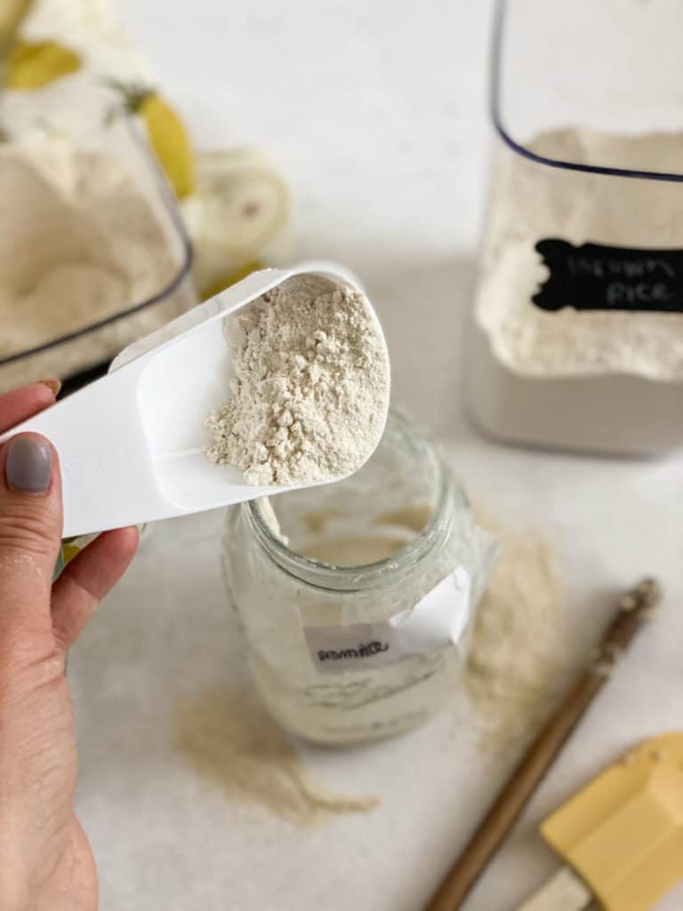 Brown rice flour being poured into a jar