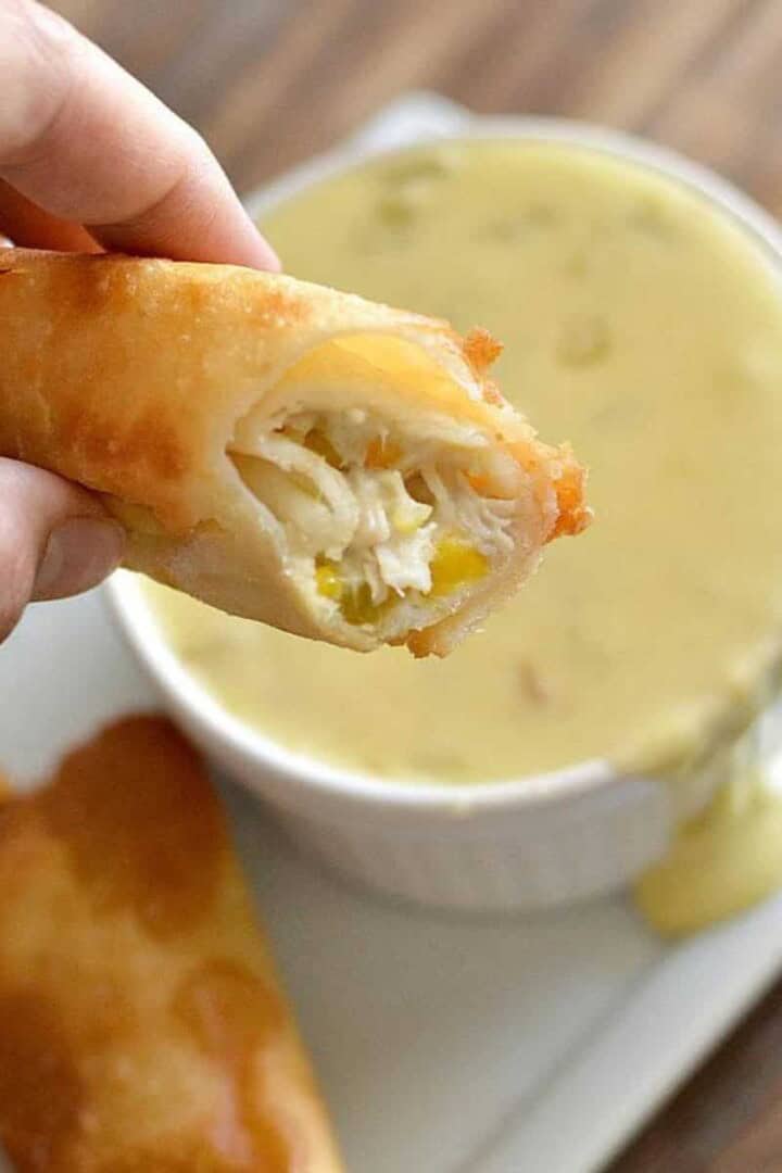 Easy Rolled Tacos being dipped