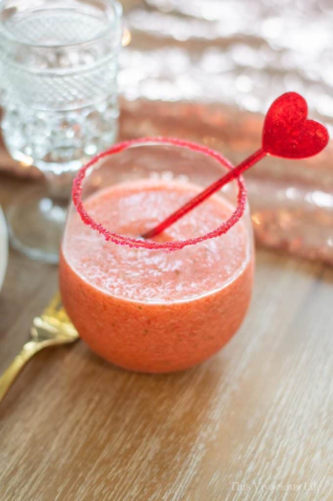 Strawberry basil margarita mocktail in a cup with a heart stirrer