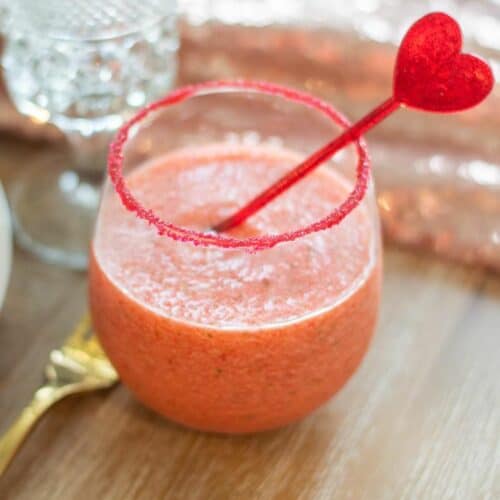 Valentines Mocktails in a glass with red heart stirrer