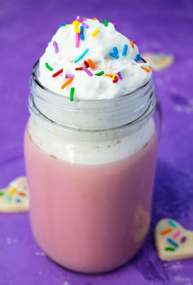 Pink hot cocoa with whipped cream and sprinkles