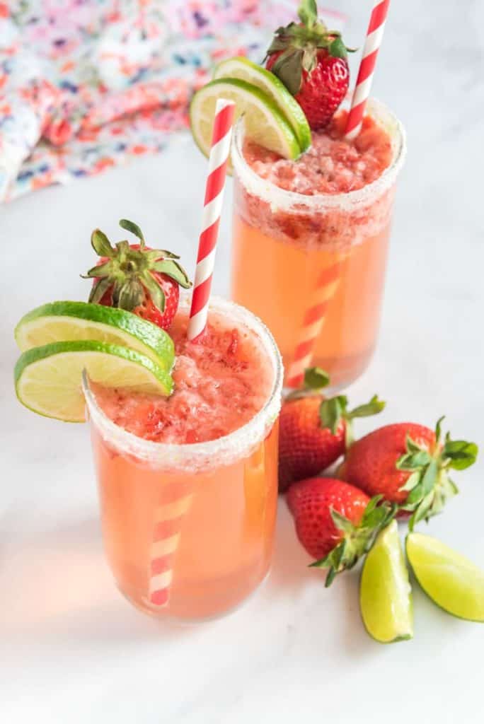 Strawberry mocktail in a glass with limes and strawberries
