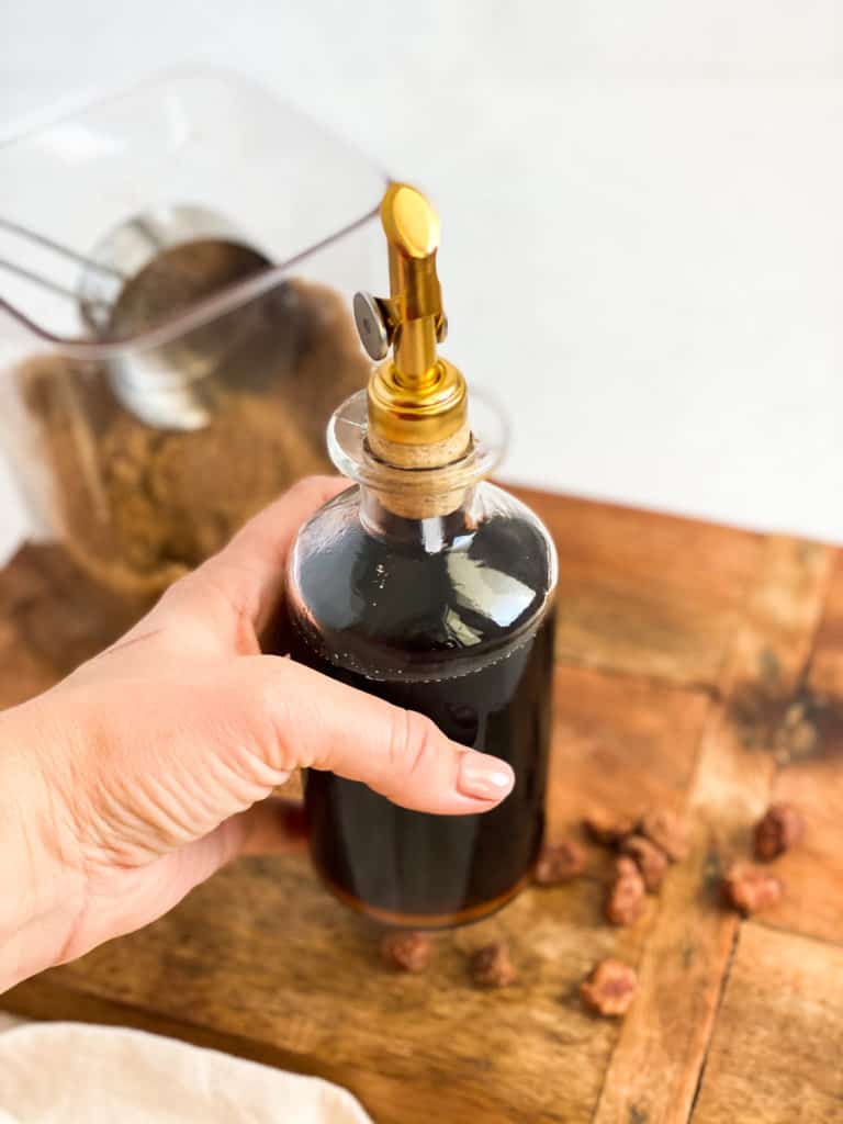 Brown Sugar Simple Syrup being held in a glass jar