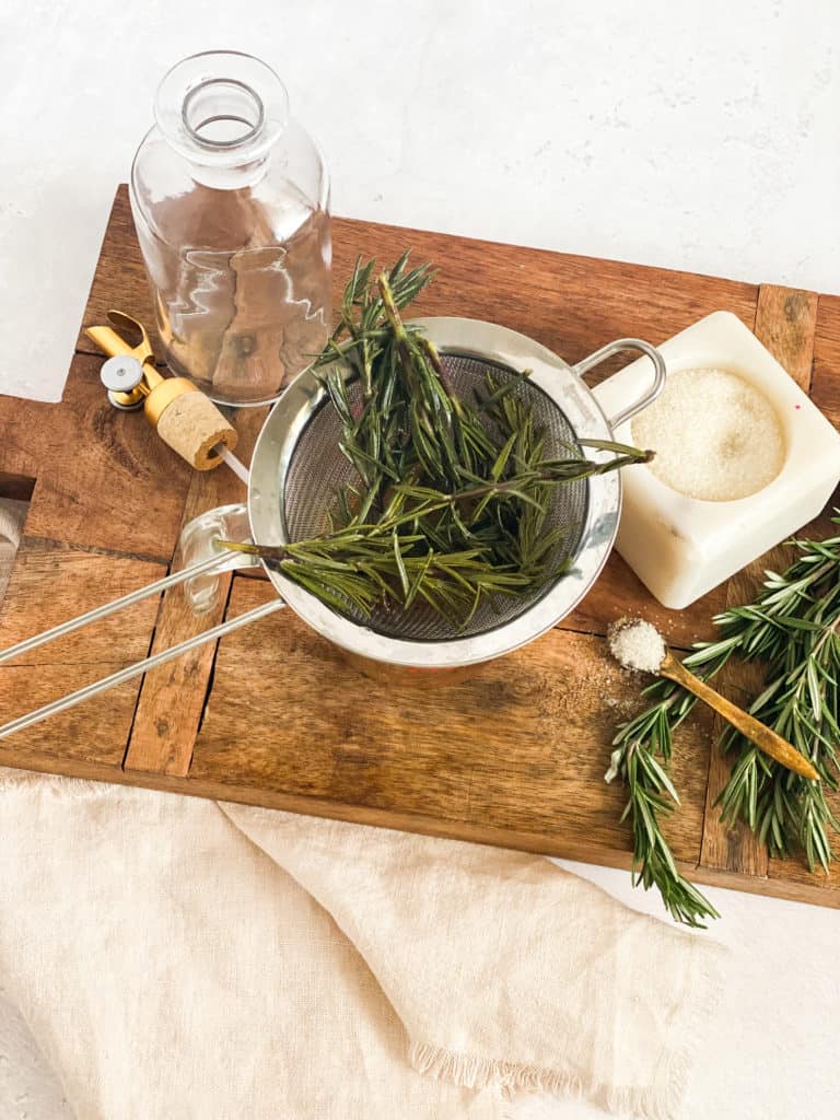 Rosemary Simple Syrup in a strainer