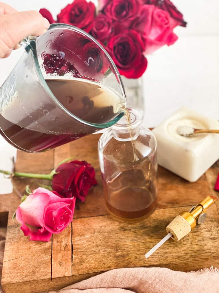 Rose Simple Syrup being poured into a glass jar