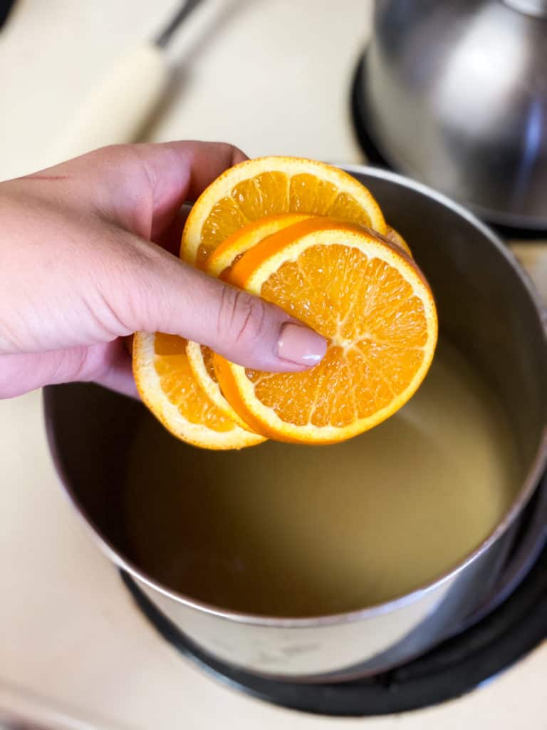 Oranges being put into a pot