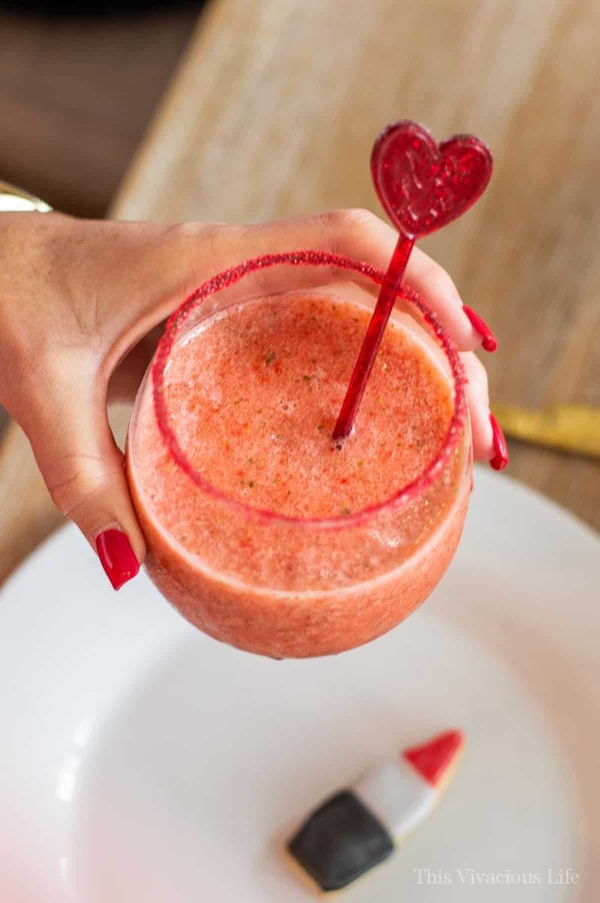 Virgin Strawberry Margarita Mocktail in a hand