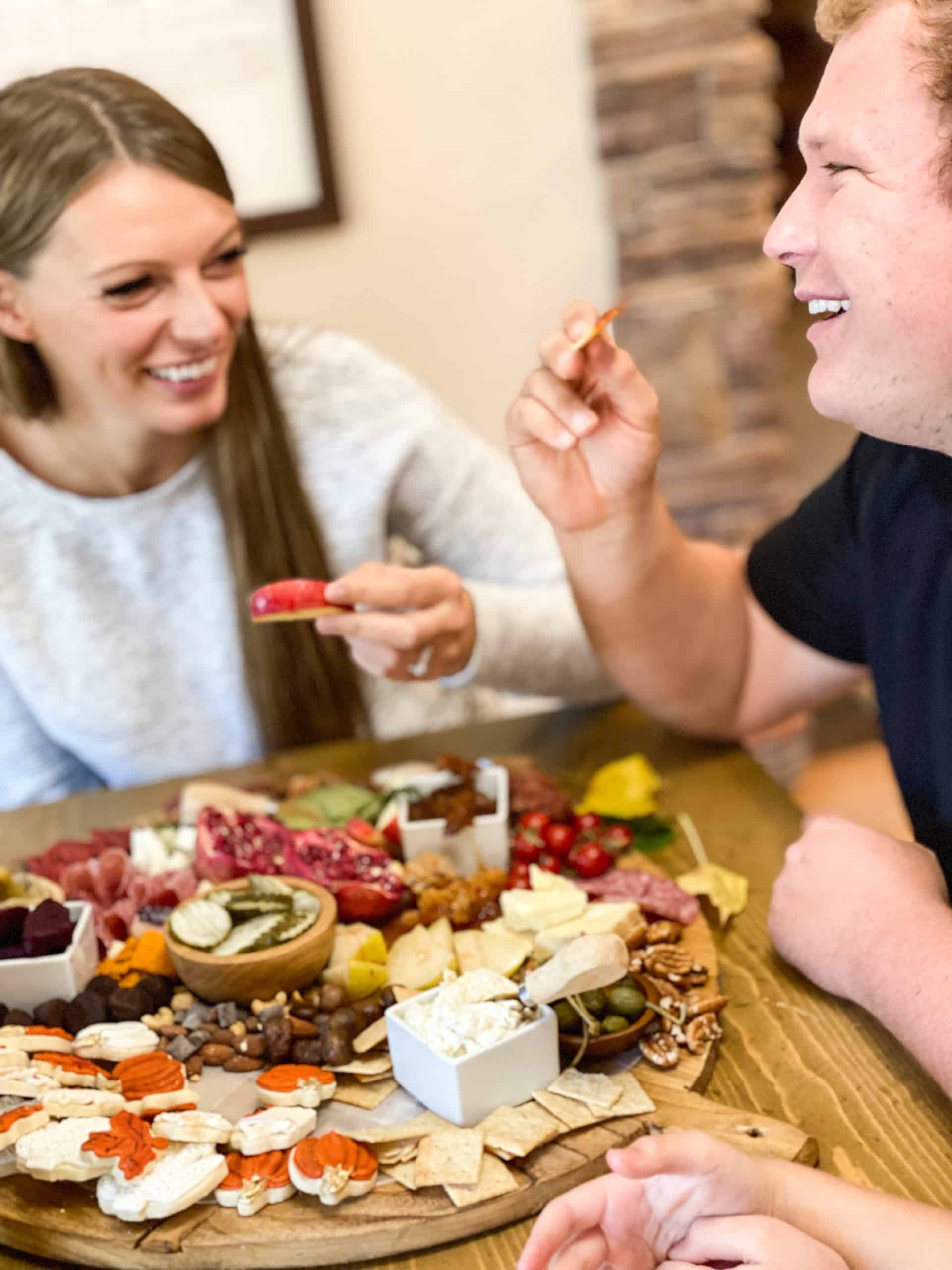 Thanksgiving Charcuterie Board with people eating