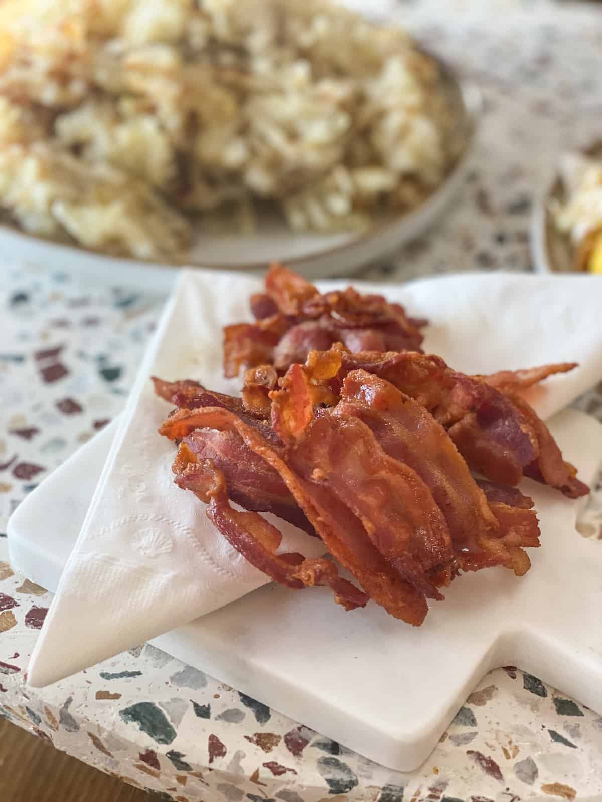 Instant Pot bacon on a white marble tray with napkin