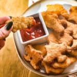 Dino nuggets air fryer recipe being dipped in ketchup