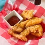 Frozen Chicken Tenders in Air Fryer cooked in a checkered basket