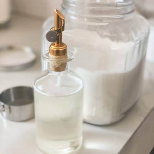 Simple syrup in a glass bottle with a gold lid