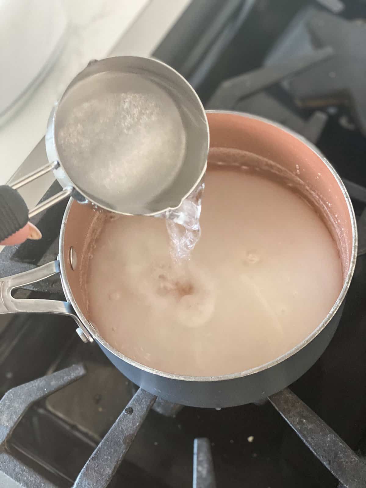 Simple Syrup Recipe being made with water being poured in